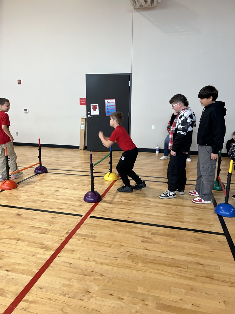 students playing at an obstacle course 