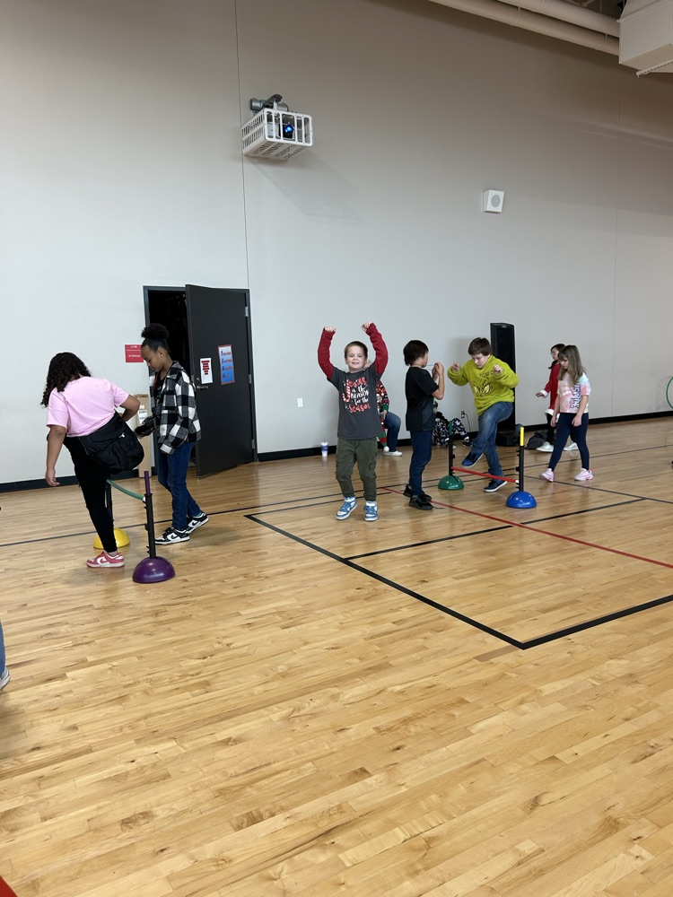 students playing at an obstacle course 