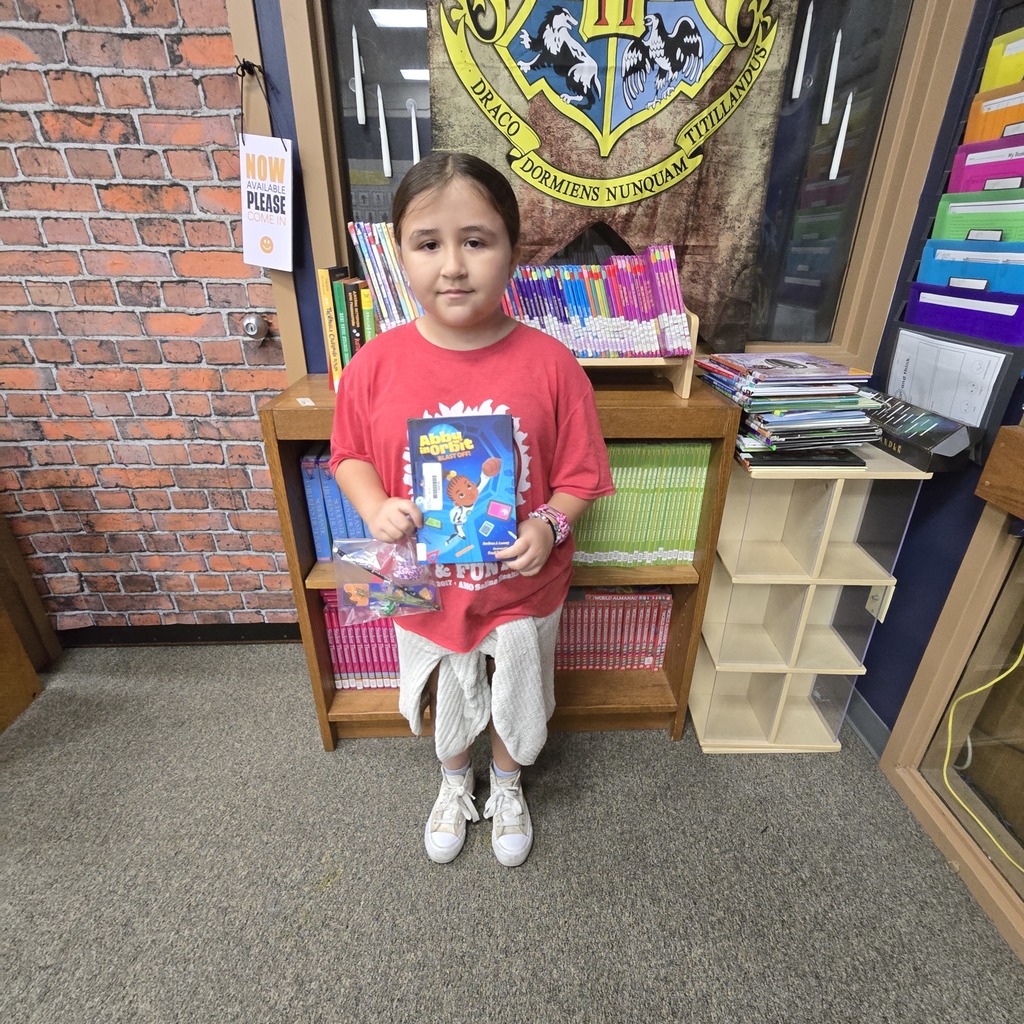 student holding book