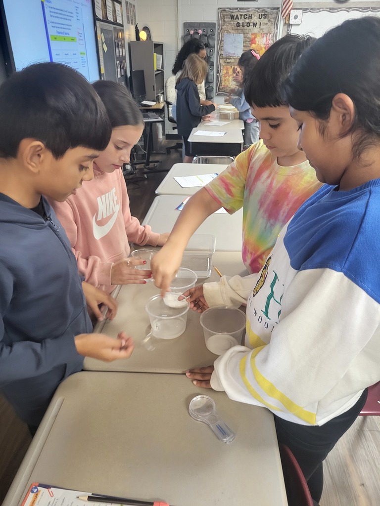 students working with graham crackers and marshmallows 