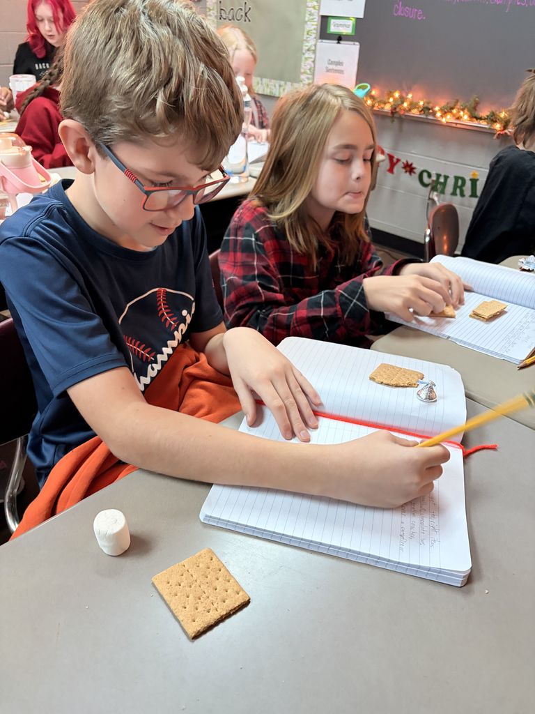 students working with graham crackers and marshmallows 