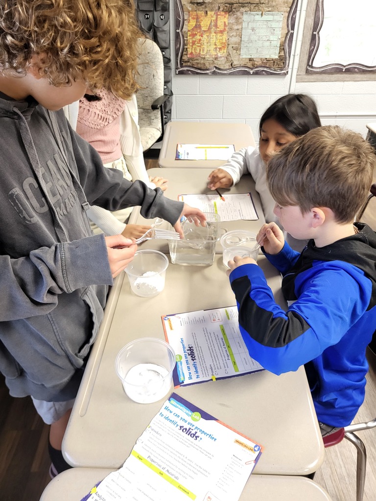 students working with graham crackers and marshmallows 