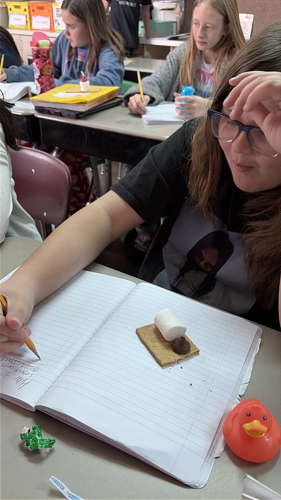 students working with graham crackers and marshmallows 
