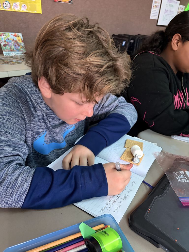 students working with graham crackers and marshmallows 