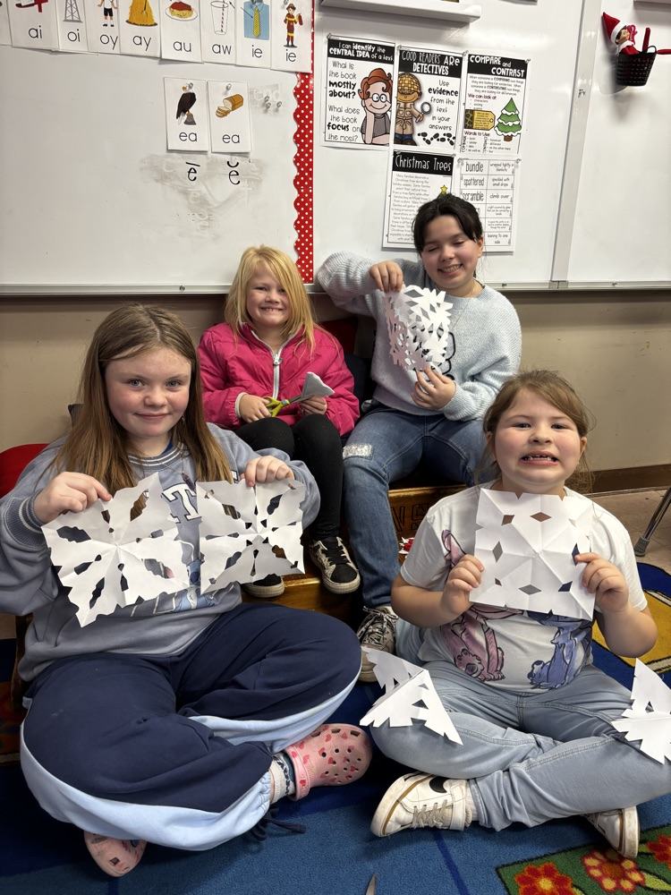 students showing their snowflakes 