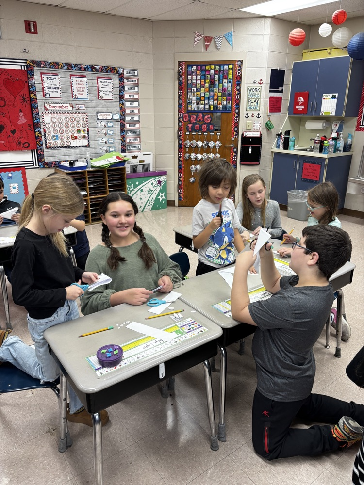students showing their snowflakes 