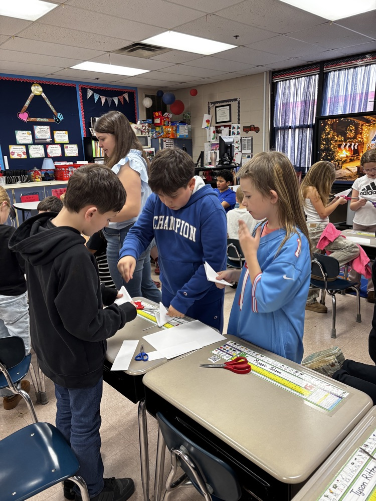 students showing their snowflakes 