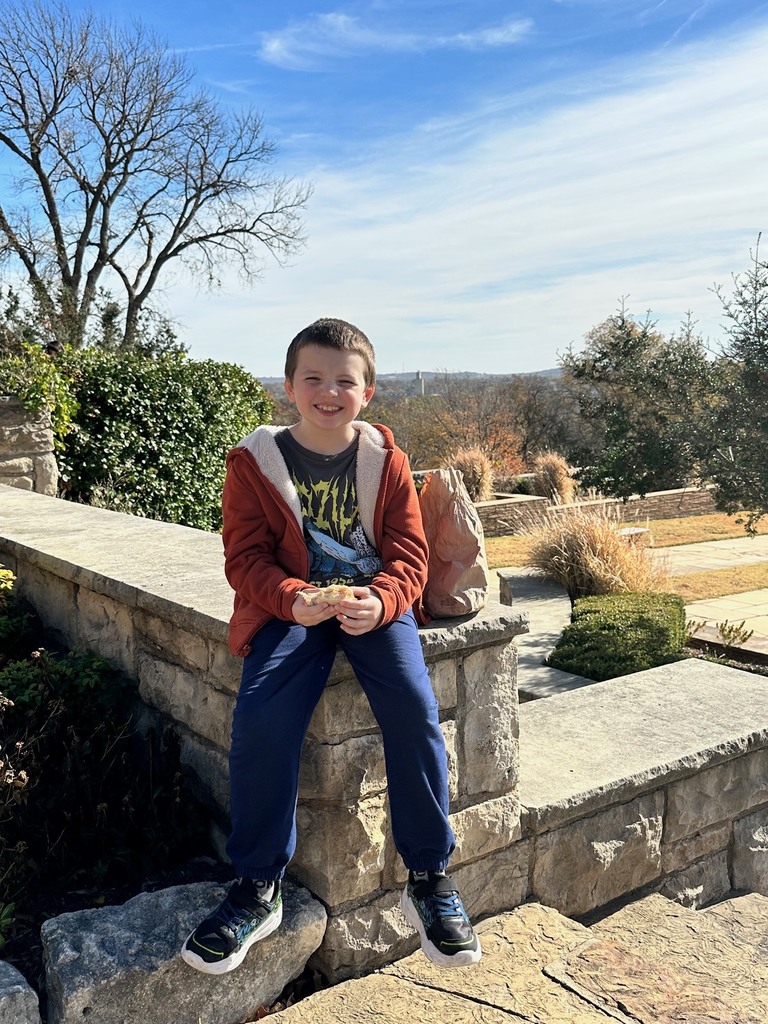 students eating lunch outside and smiling