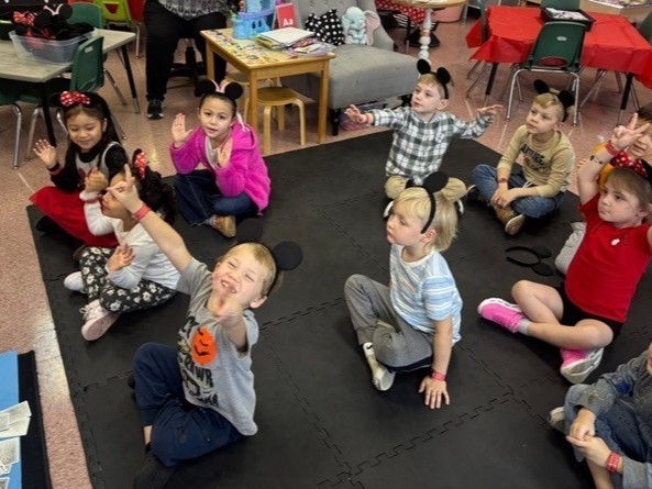 Pre K students engaging in a Disney themed lesson.