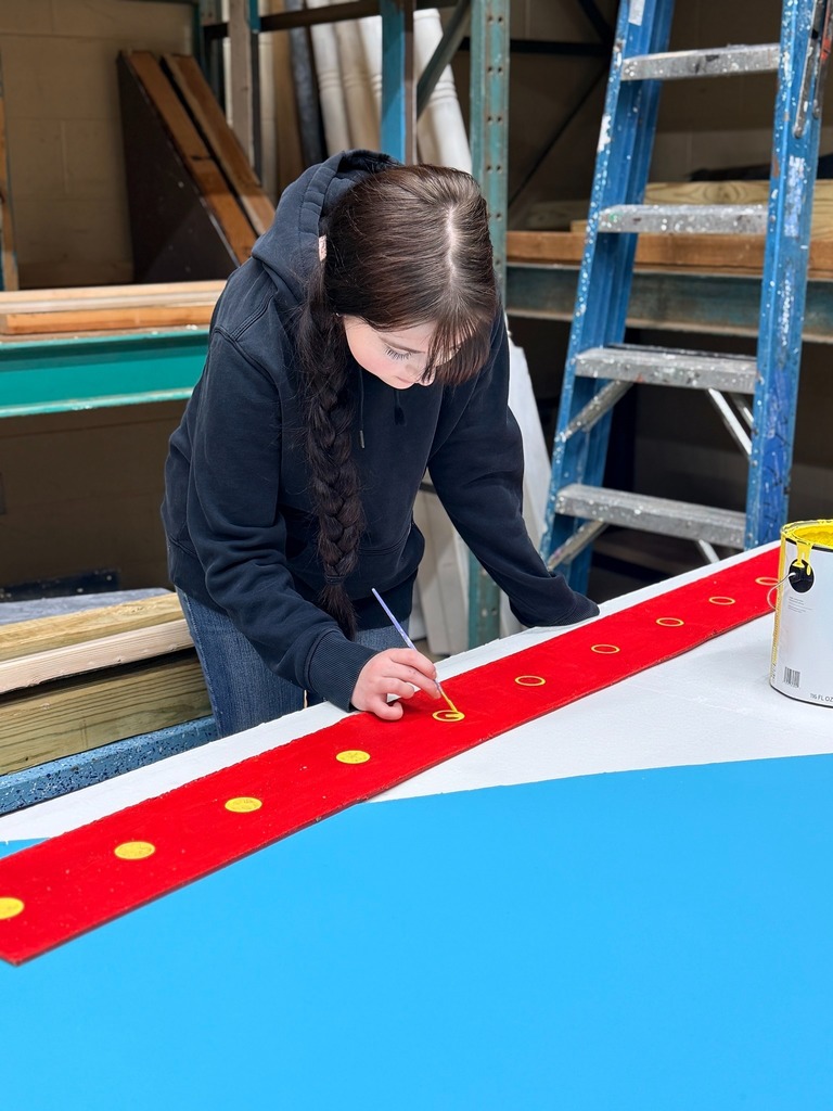 High school student working on sets in Theater Production class.