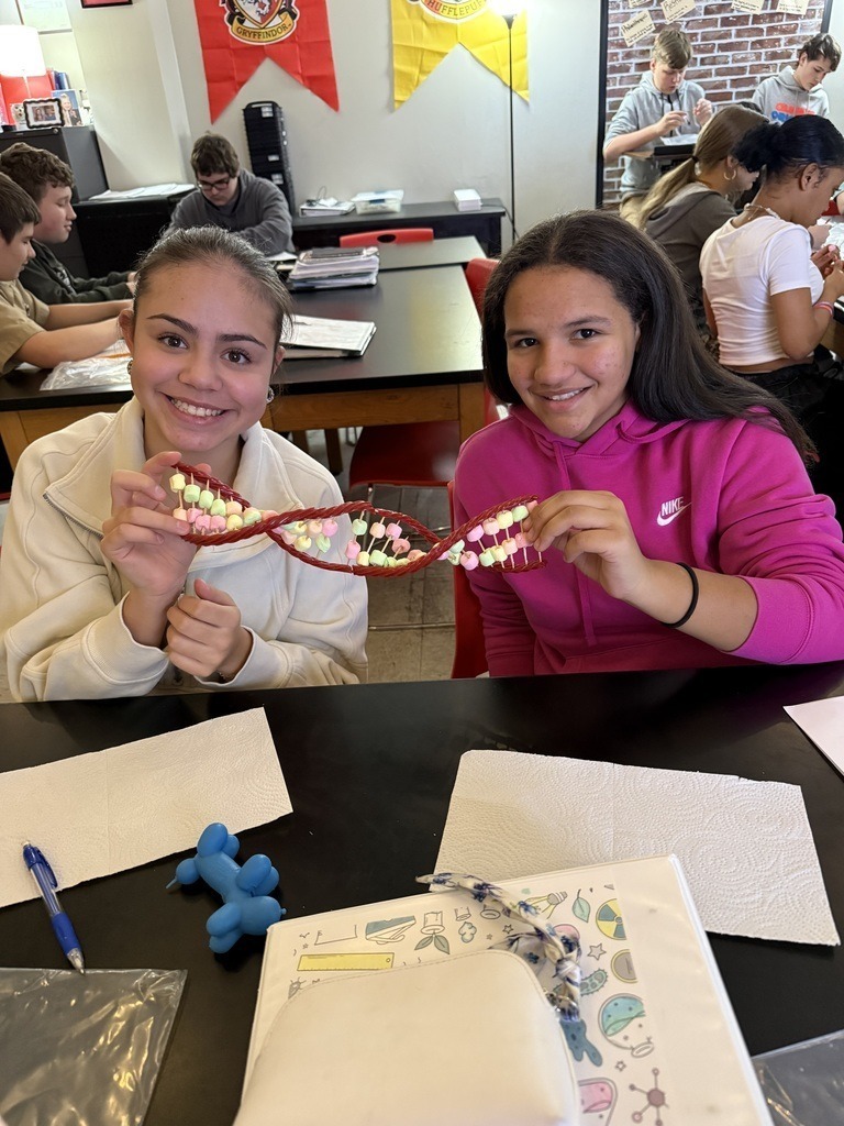Junior High students creating D.N.A strands with candy.