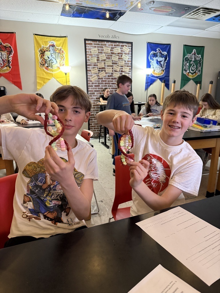 Junior High students creating D.N.A strands with candy.