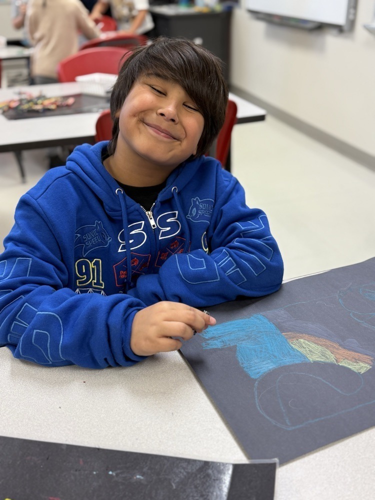 Elementary students working on cat portraits.