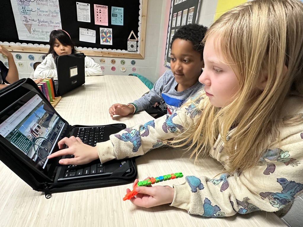 students looking at computer doing research