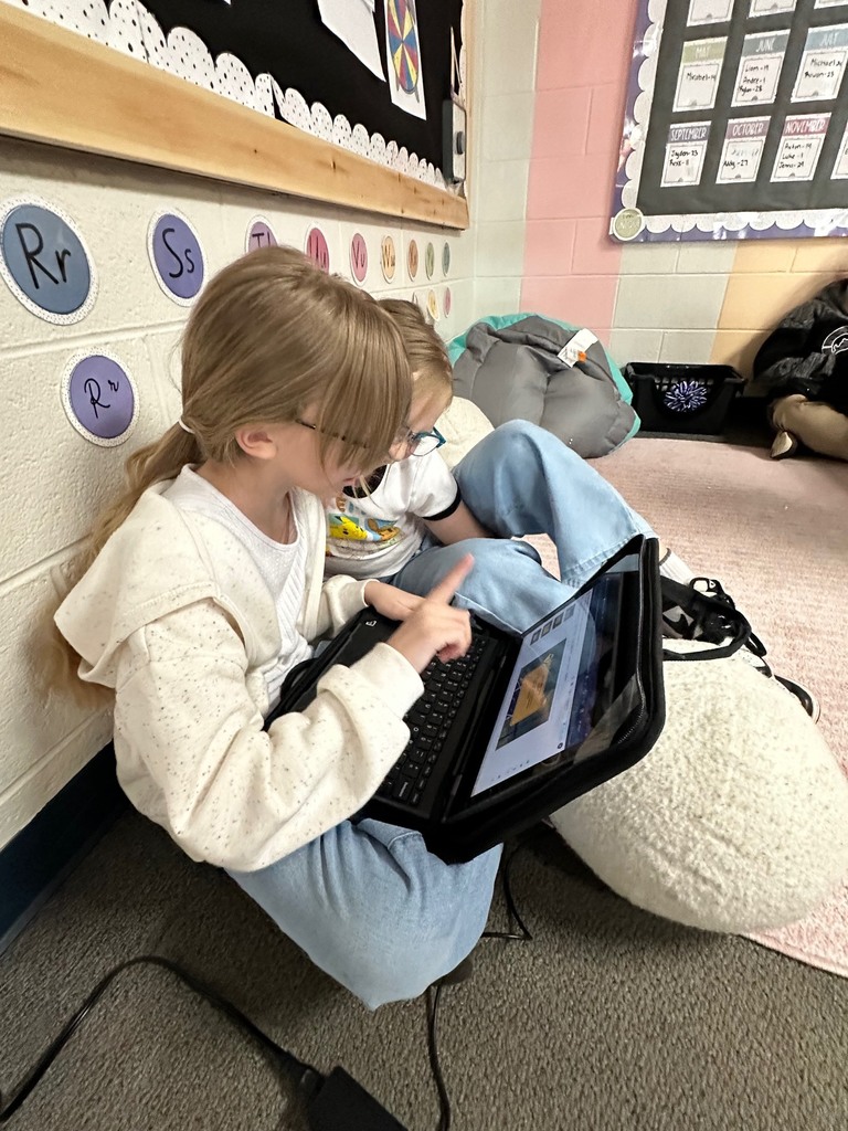 students looking at computer doing research