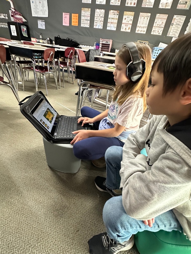 students looking at computer doing research