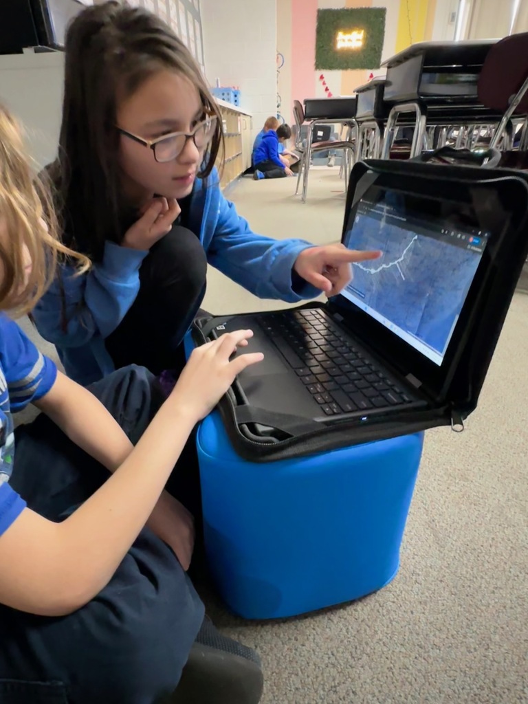 students looking at computer doing research