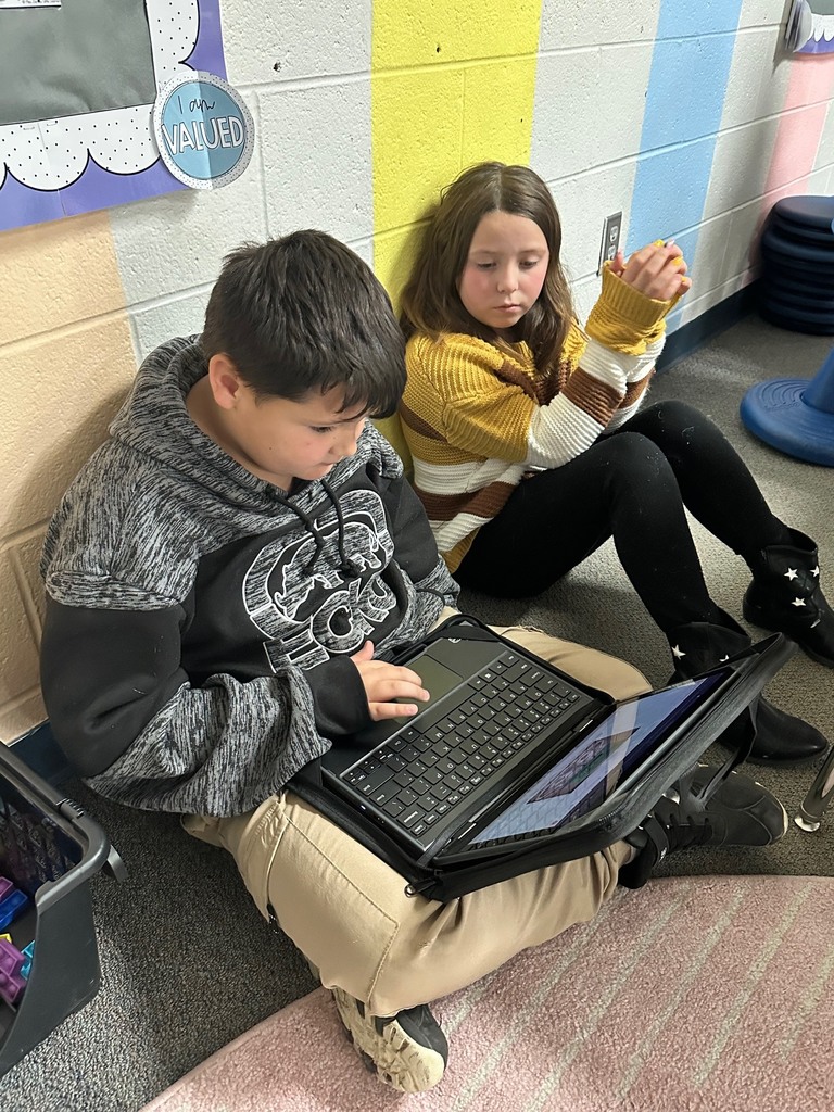 students looking at computer doing research