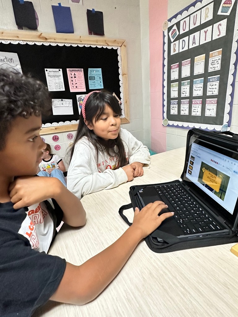 students looking at computer doing research