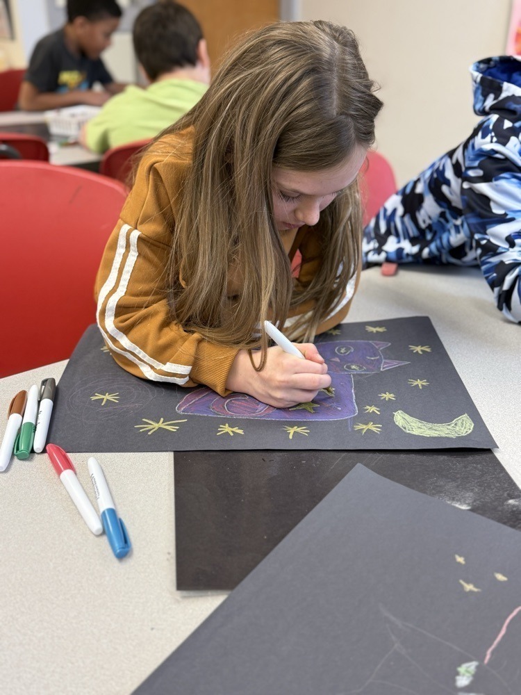 Student working on her art work in school