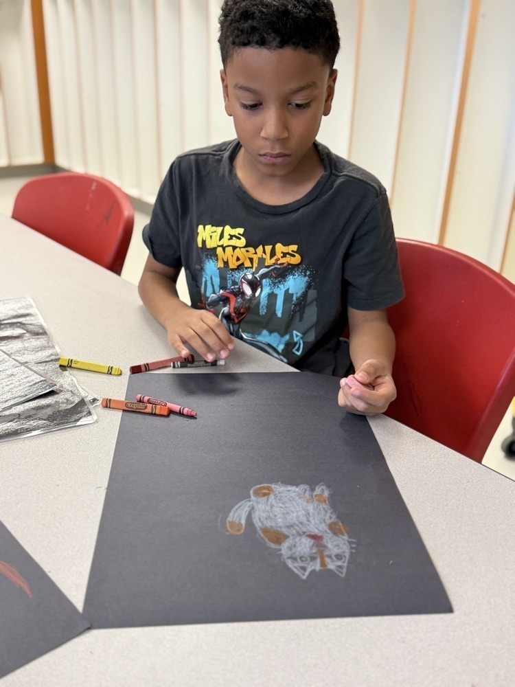 Student focused on his art work and making it the best he can