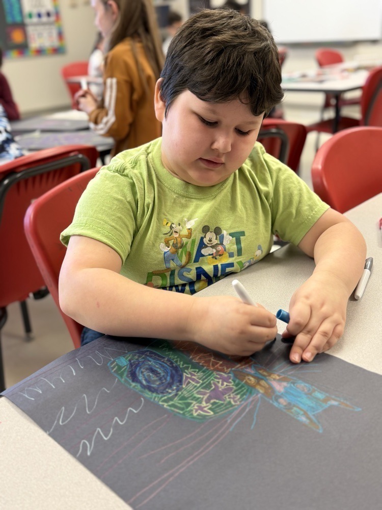 Student working diligently on his art work