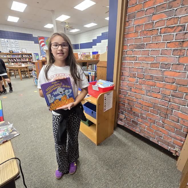 student holding book