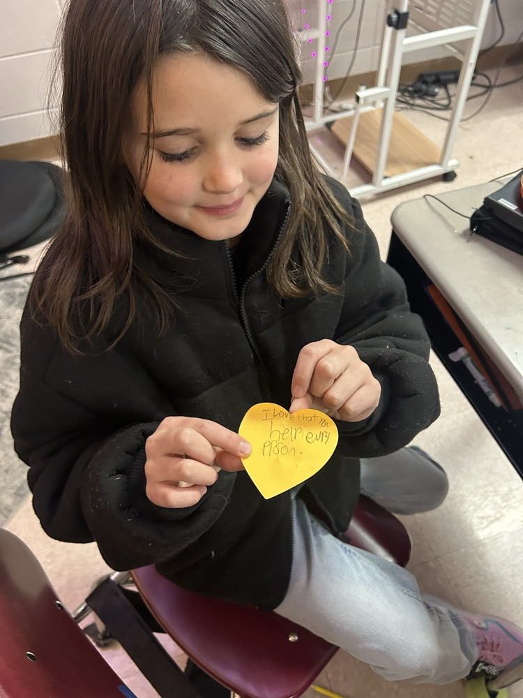 student writing on sticky note 