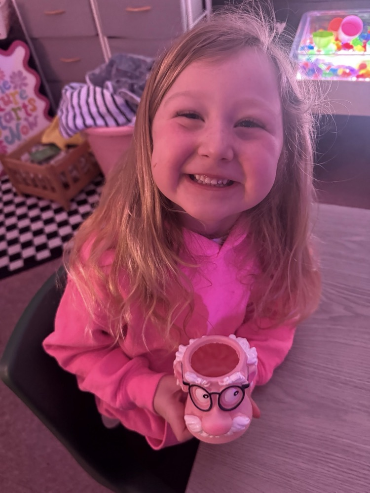 student holding an old man cup