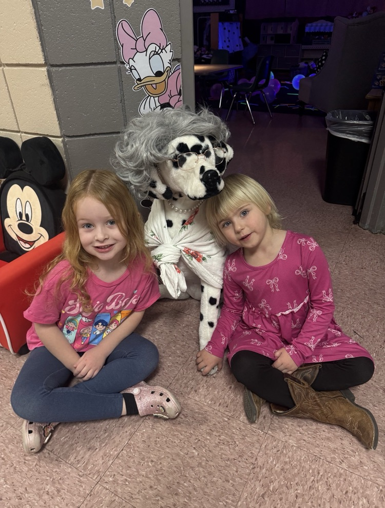 student sitting next to a dressed up puppy
