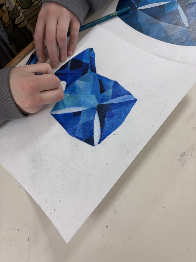 Art 1 students are diving into colored pencil techniques with dazzling gemstone drawings! From smooth blending to bold highlights, their shading skills are shining through. Advanced students pushed themselves even further by working with pastel pencils for the first time. This marks the first realistic, full-color drawing of the semester—and their growth is seriously blowing us away!