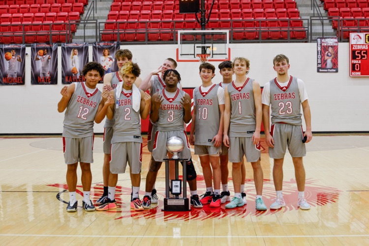 boys basketball team with a trophy