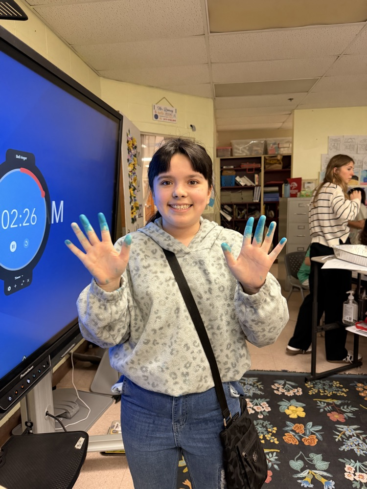 student with messy hands from experiment 