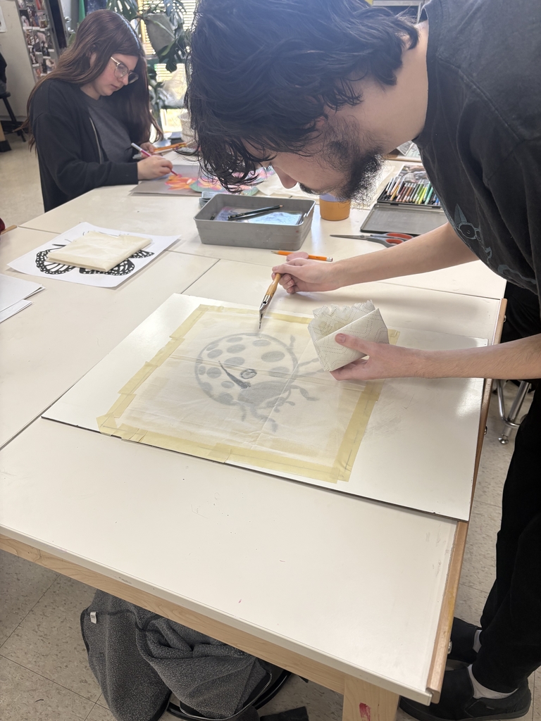 Student working on the batik art of a ladybug