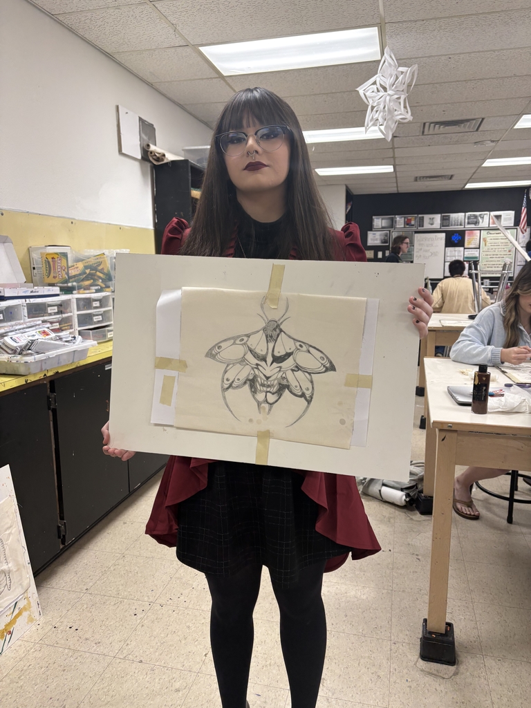 Student holding her Baltik project in studio art