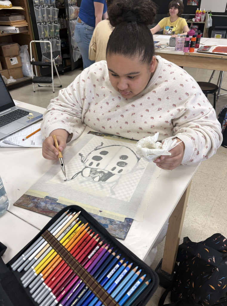 Students are discovering the exciting art of Batik! Batik is a fabric art technique where melted wax is applied to cloth to block out certain areas before dyeing. The wax is drawn on the fabric with a traditional tjanting tool, then the piece is hand painted. To reveal the final masterpiece, students remove the wax by ironing the fabric between sheets of newsprint and then washing away any remaining residue—unveiling bold contrasts, luminous color, and rich designs.