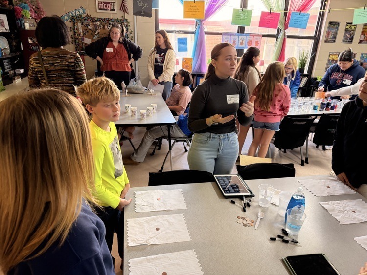 Fifth graders doing science experiments with R.S.U Students.