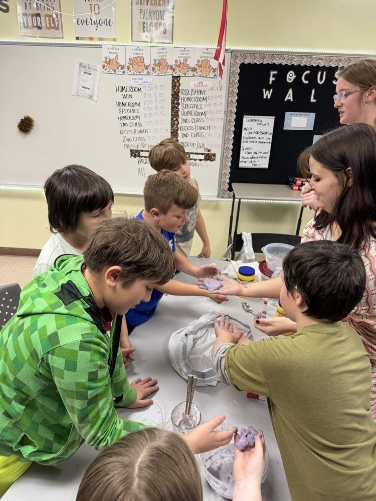 Fifth graders doing science experiments with R.S.U Students.