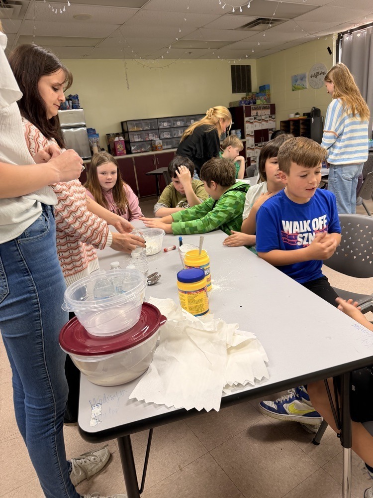 Fifth graders doing science experiments with R.S.U Students.