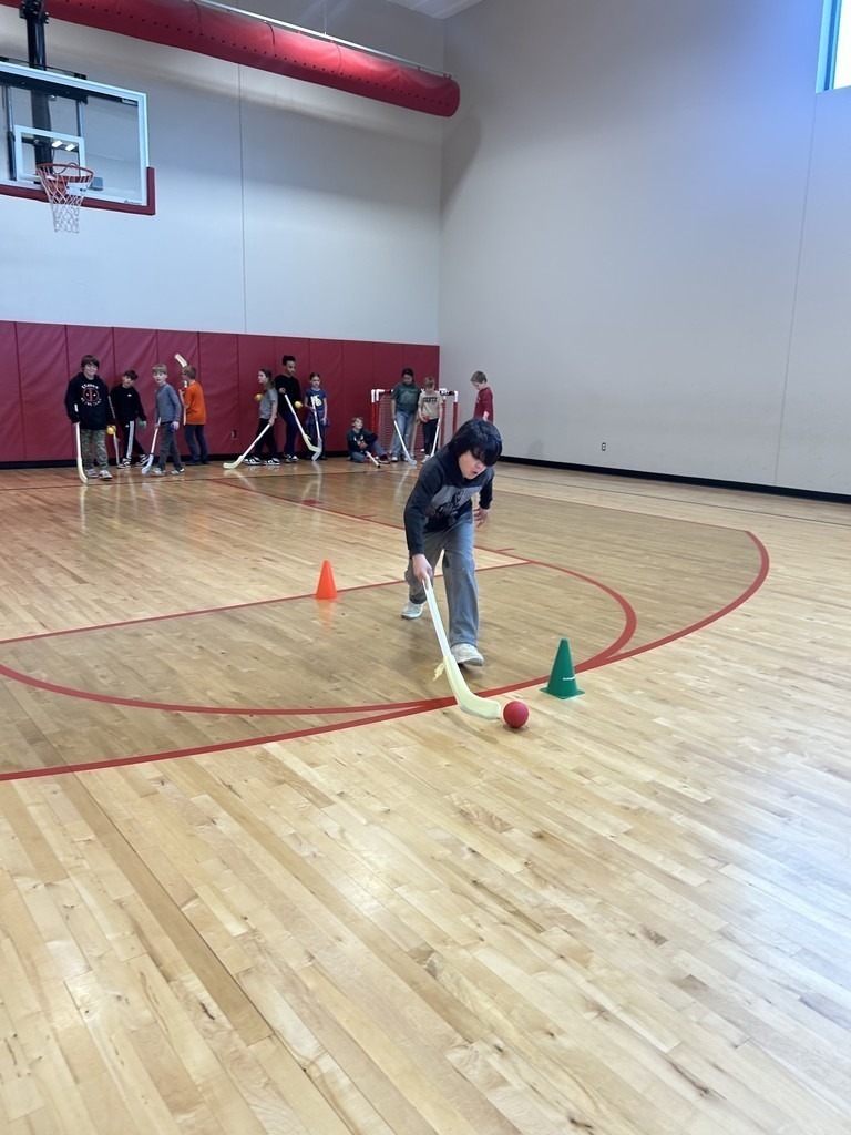 Claremont students learning hockey skills.