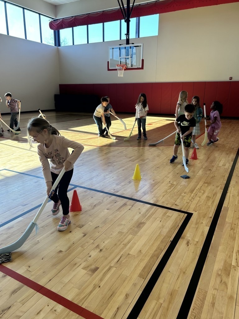 Claremont students learning hockey skills.