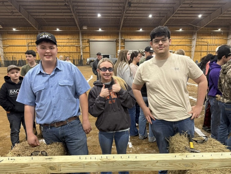 Three students smiling