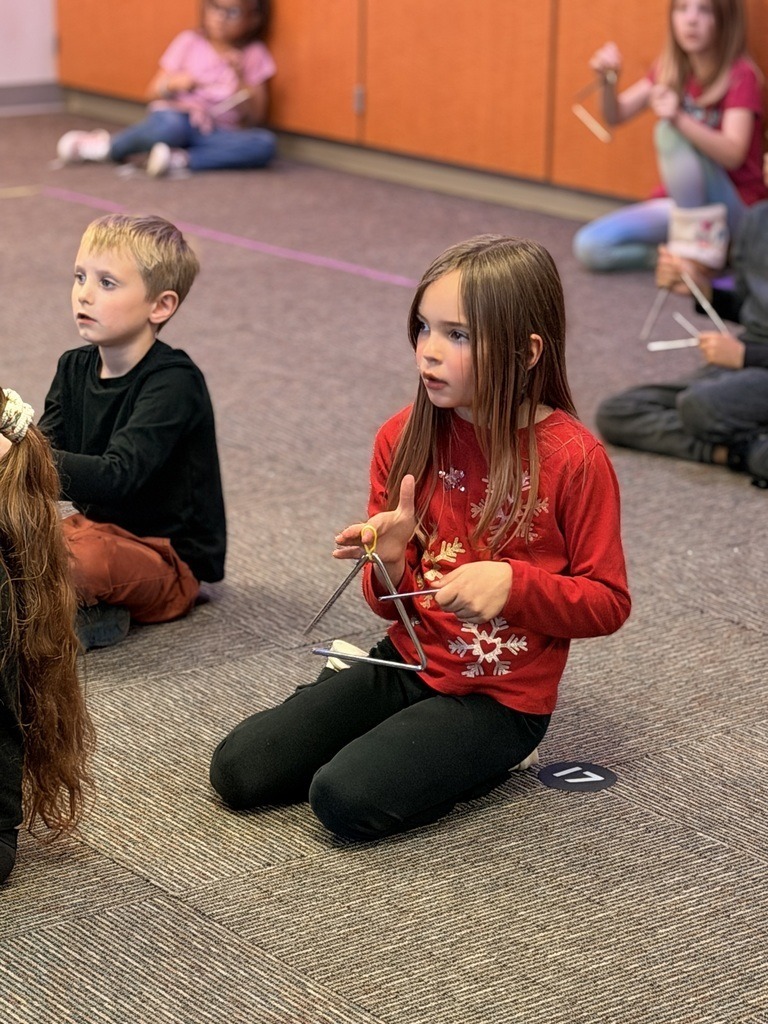Catalayah Elementary student playing the triangle.