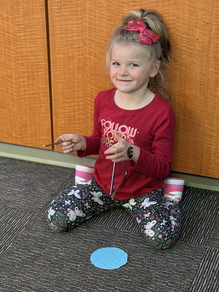 Catalayah Elementary student playing the triangle.