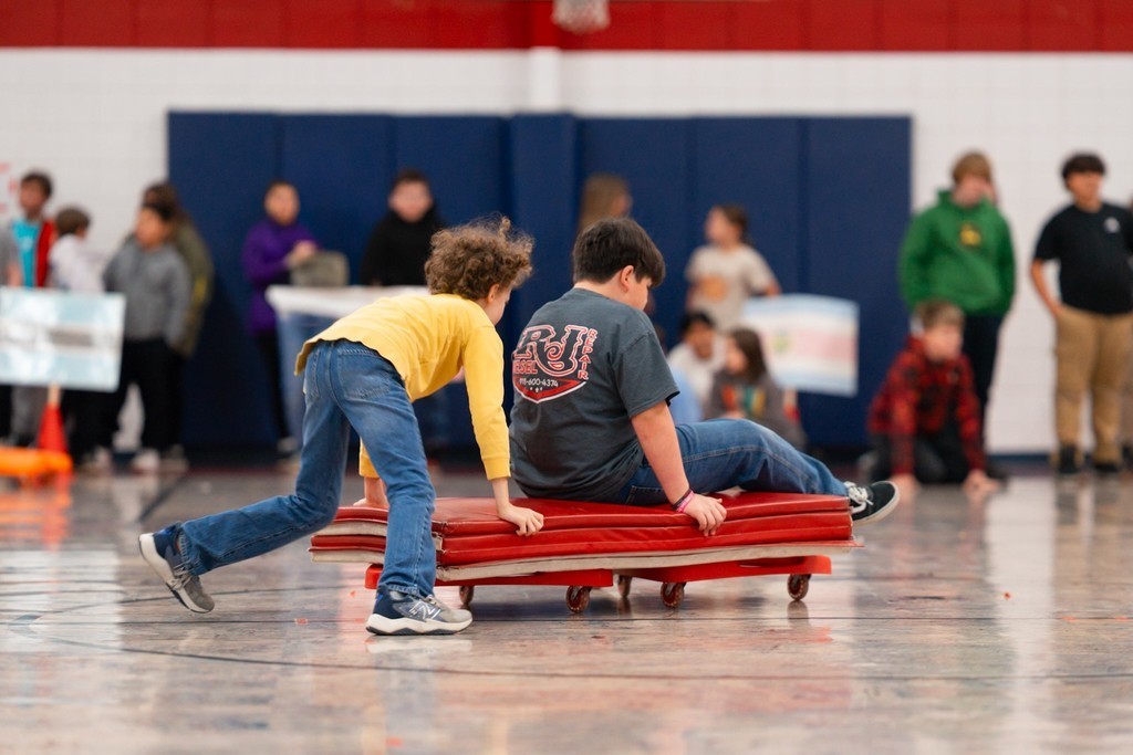 Roosa fifth graders playing bobsled.
