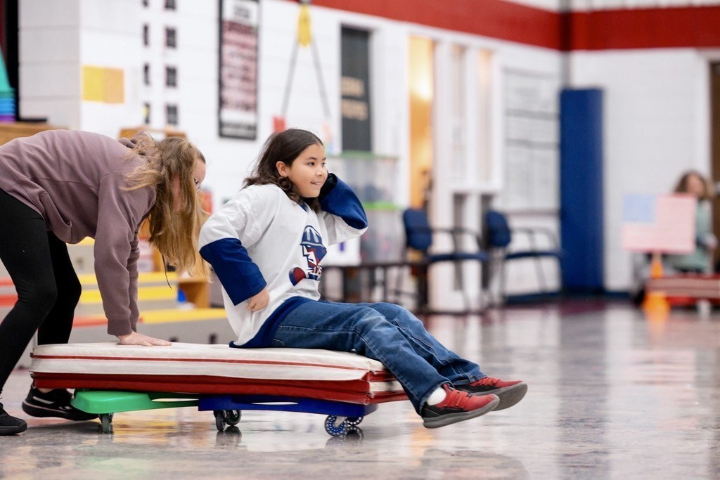 Roosa fifth graders playing bobsled.