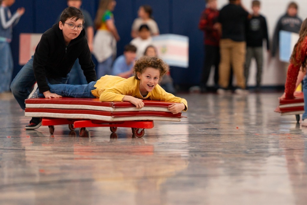 Roosa fifth graders playing bobsled.