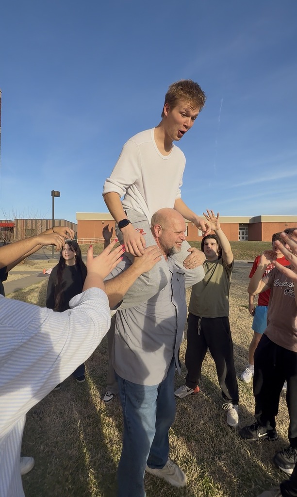 Student sitting on Mr. Doonkeens shoulders showing students the new move.