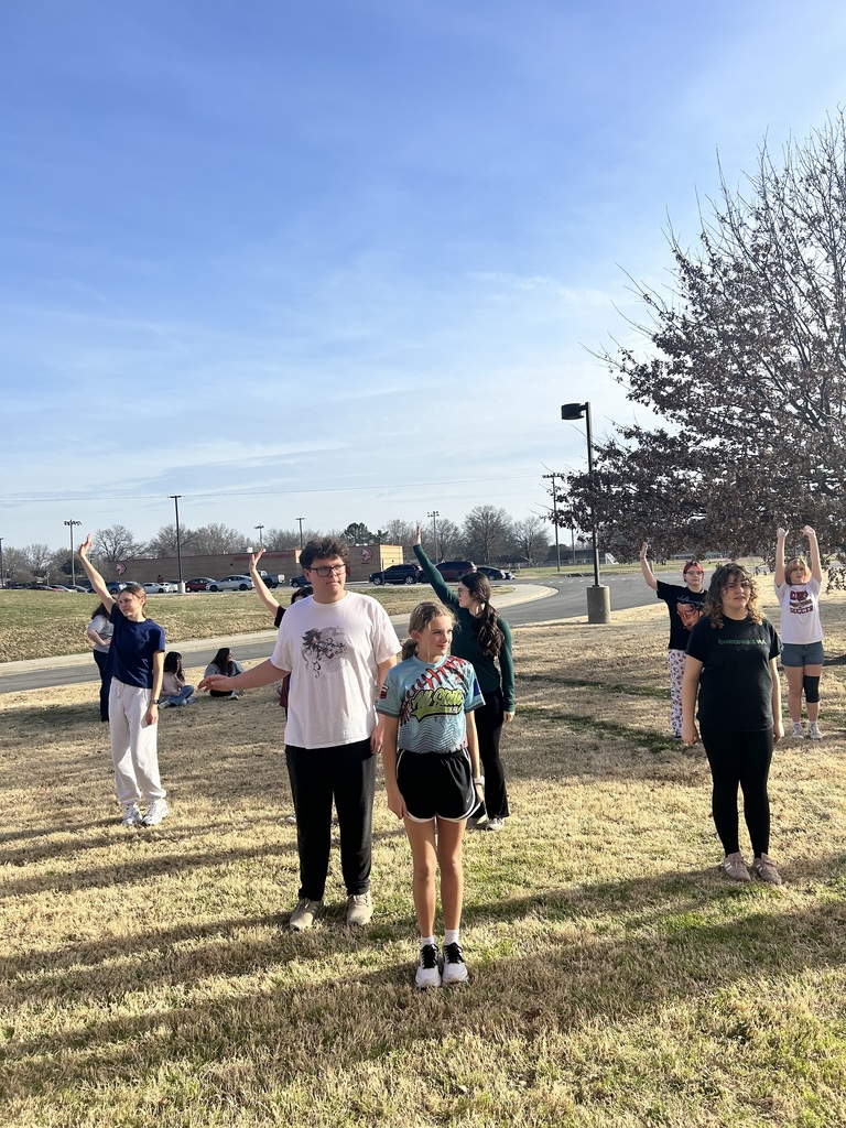 Students having musical practice outside in the warm sun