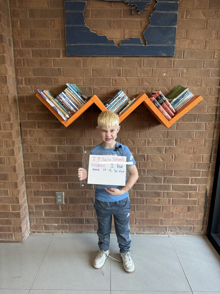 boy holding white board